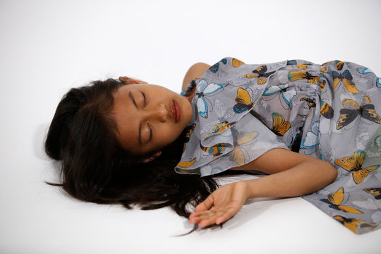 Pretty asian girl in gray blue butterflies dress sleeps - Powered by Adobe
