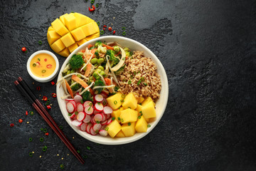 Asian style Vegan salad bowl with edamame, vegetable stir-fry mix, wholegrain rice, quinoa, mango...
