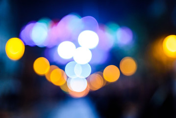 Defocused urban night background with colorful circles.