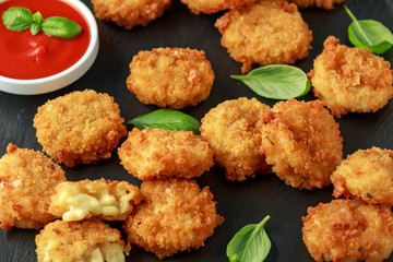 Fried Mac, macaroni and Cheese Bites in breadcrumbs with ketchup sauce