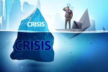 Crisis concept with businessman on iceberg
