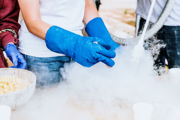 Pouring liquid nitrogen with protective glove.