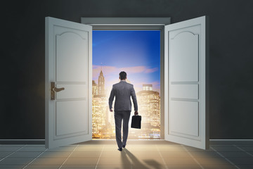 Fototapeta premium Businessman entering big large door