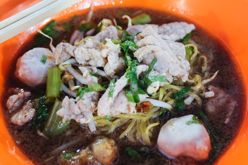Bowl of noodle soup with pork, meat ball and morning glory (Moo nam tok), Thailand - food concept.