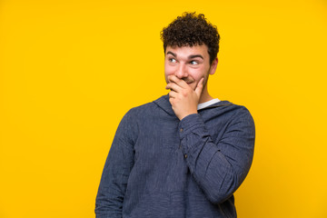 Young man over isolated yellow wall thinking an idea