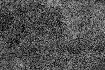 A fine texture of grey bath towel. A beige carpet texture.