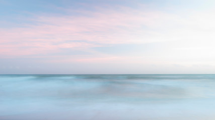 Beautiful artistic colorful landscape image of blurred waves at sunset in Devon Enlgand