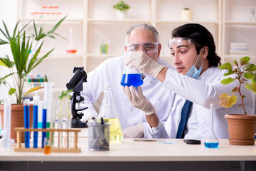 Two chemists working in the lab