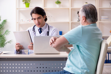 Old man visiting young male doctor 