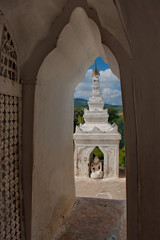 Naklejka premium Myanmar. Hsin Phyu Shin Pagoda was built in 1816 with special elegance, includes a multi-tiered gallery with small pagoda towers and symbolizes the cosmogonic structure of the universe
