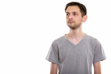 Obraz premium Studio shot of young man thinking and looking up