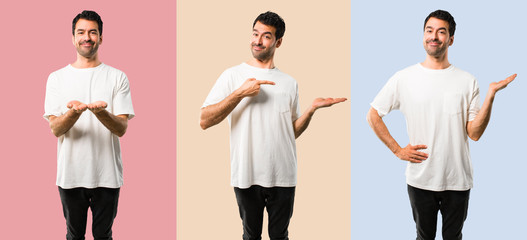 Set of Young man with white shirt holding copyspace imaginary on the palm to insert an ad on...