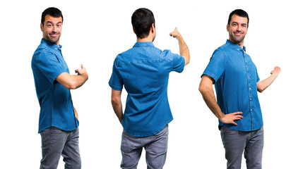 Set of Handsome man with blue shirt pointing back with the index finger