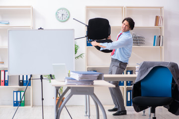 Young male employee unhappy with excessive work 
