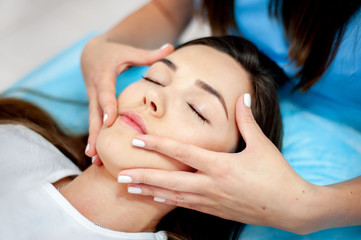 Obraz na płótnie Canvas Face massage. Cosmetic procedures for the face. Cosmetology.