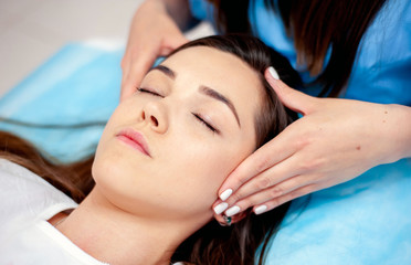 Fototapeta na wymiar Face massage. Cosmetic procedures for the face. Cosmetology.