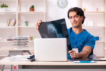 Young handsome doctor radiologist working in the clinic