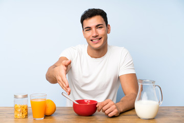 Handsome man in having breakfast handshaking after good deal