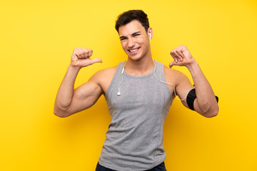 Handsome sport man over isolated background proud and self-satisfied