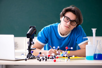 Young male student in the classroom 