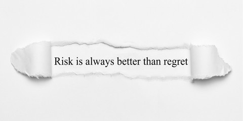 Risk is always better than regret on white torn paper