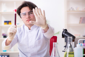 Young male biochemist working in the lab 