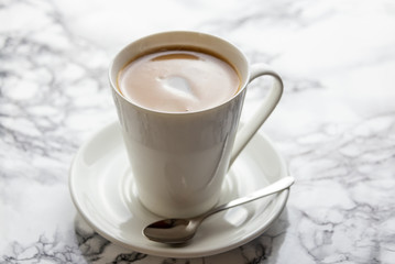 Front view of a delicious and tasty cup of freshly made coffee