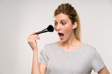 Fototapeta premium Young blonde woman with makeup brush