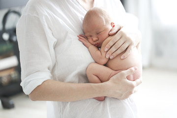 Mom and baby, newborn sleeping in mother hands
