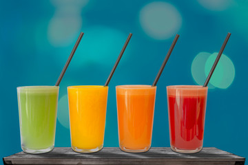 Various freshly squeezed fruits juices on the table