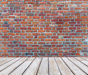 White wooden deck floor with red brick background