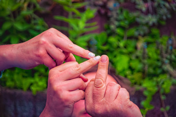 Three different middle fingers are held up