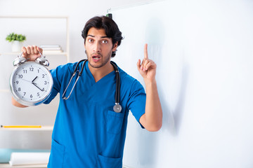 Young male doctor in front of whiteboard 