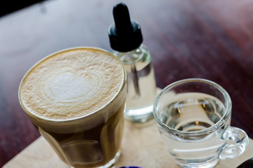 The cup of hot coffee with sweet syrup