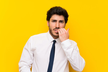 Businessman on isolated yellow background nervous and scared