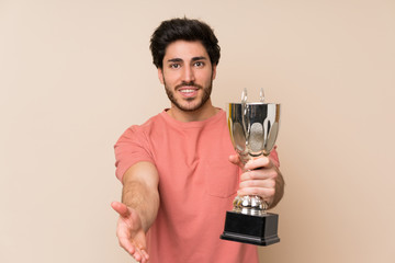 Handsome man holding a trophy