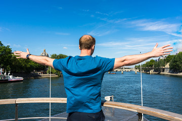 Happy man boat cruise on the Bastille day on river seine, Paris, France