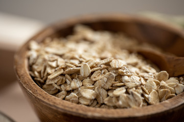 Closeup of oat flakes in wood bowl