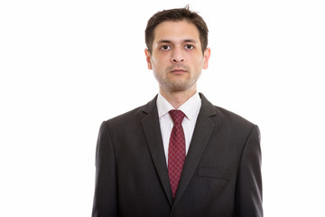 Studio shot of young businessman looking at camera