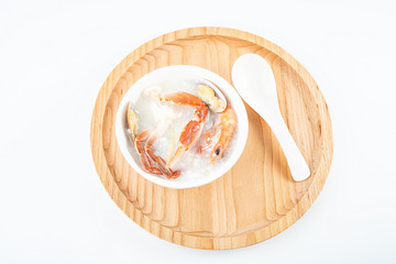 Delicious crab seafood porridge in a bowl on white background