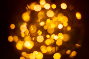 Obraz premium Yellow bokeh lights from the lamp convey warmth, lights on bokeh as background, bokeh light abstract background, Blurred blur, darkness concept