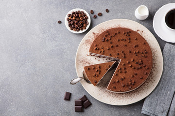 Tiramisu cake with chocolate decotaion on a plate. Grey stone background. Top view. Copy space. - obrazy, fototapety, plakaty