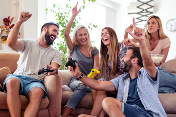 Friends playing video games at home