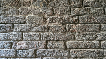 Brick wall. Texture of vintage Grey old wall in Venice. Ancient Bricks Stucco Dark Gray background.  Grunge Granite Stone Wall.