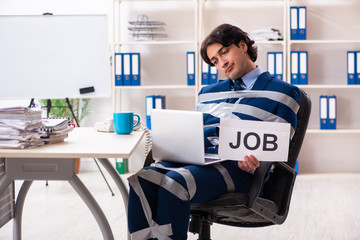 Young tied male employee in the office 