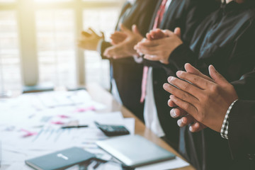 Successful business group happy, clapping at the meeting happily.
