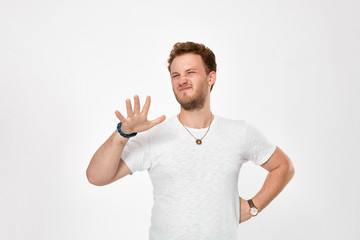 Studio shot of a handsome young man expressing emotion of dissatisfaction.