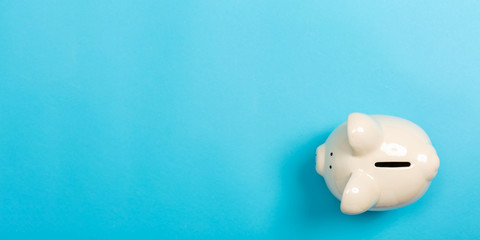 A piggy bank saving and investment theme on a blue paper background