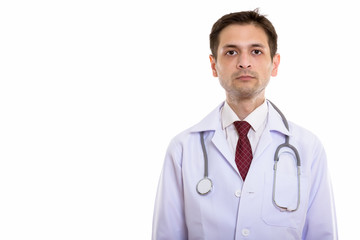 Studio shot of young man doctor looking at camera