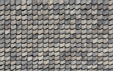 Gray tiles on the roof of an old house